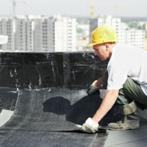 A man working on the roof of a building.