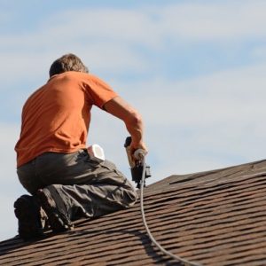 A man working on the roof of his house